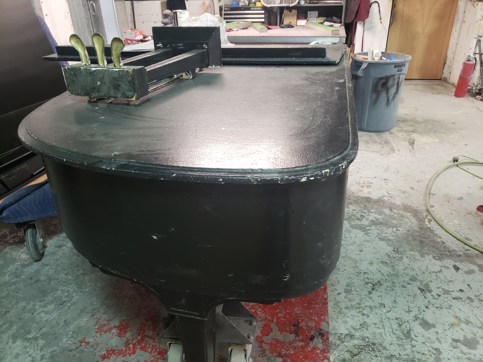 The same grand piano before restoration, scratched and worn