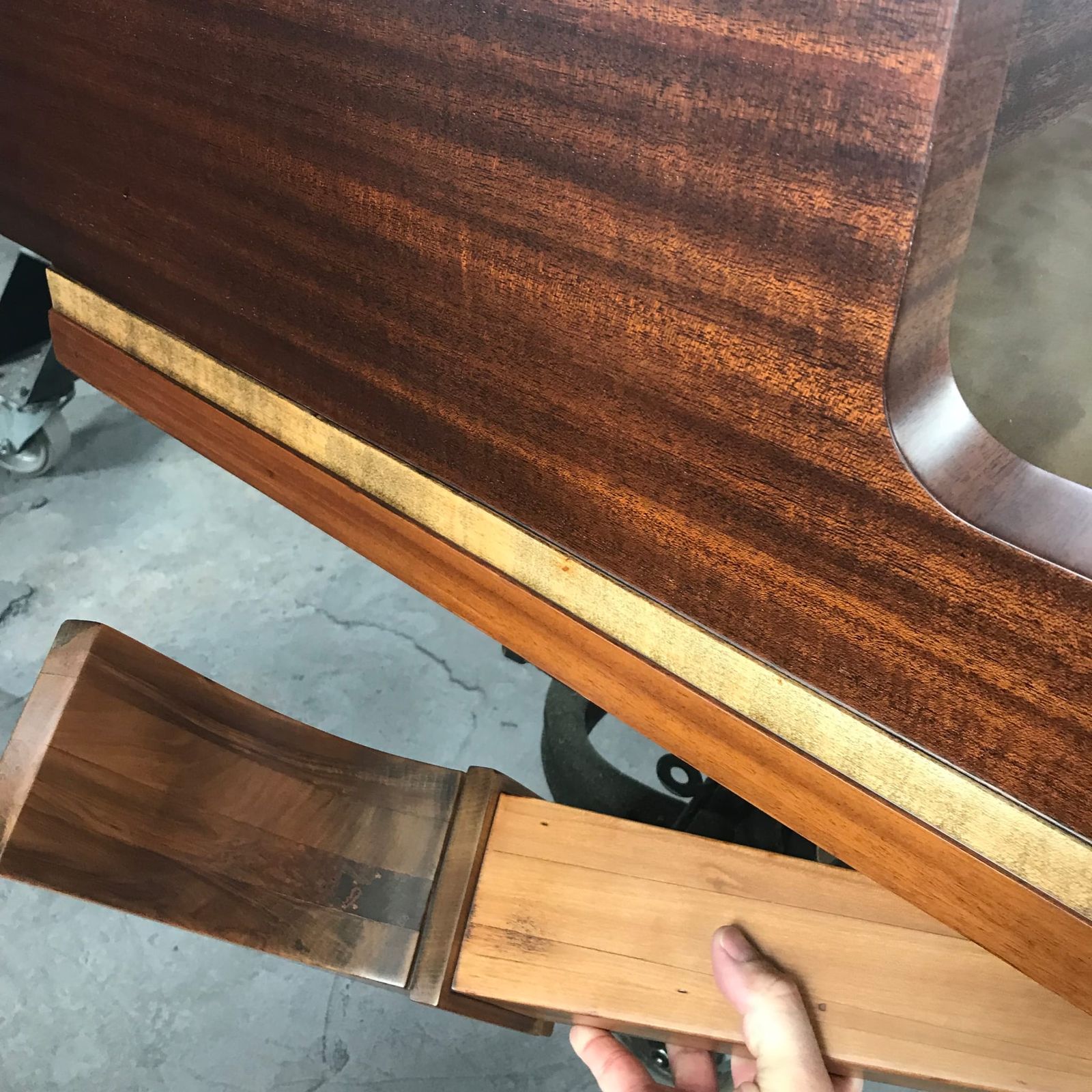 Mahogany piano trim detail with gold band, hand polished
