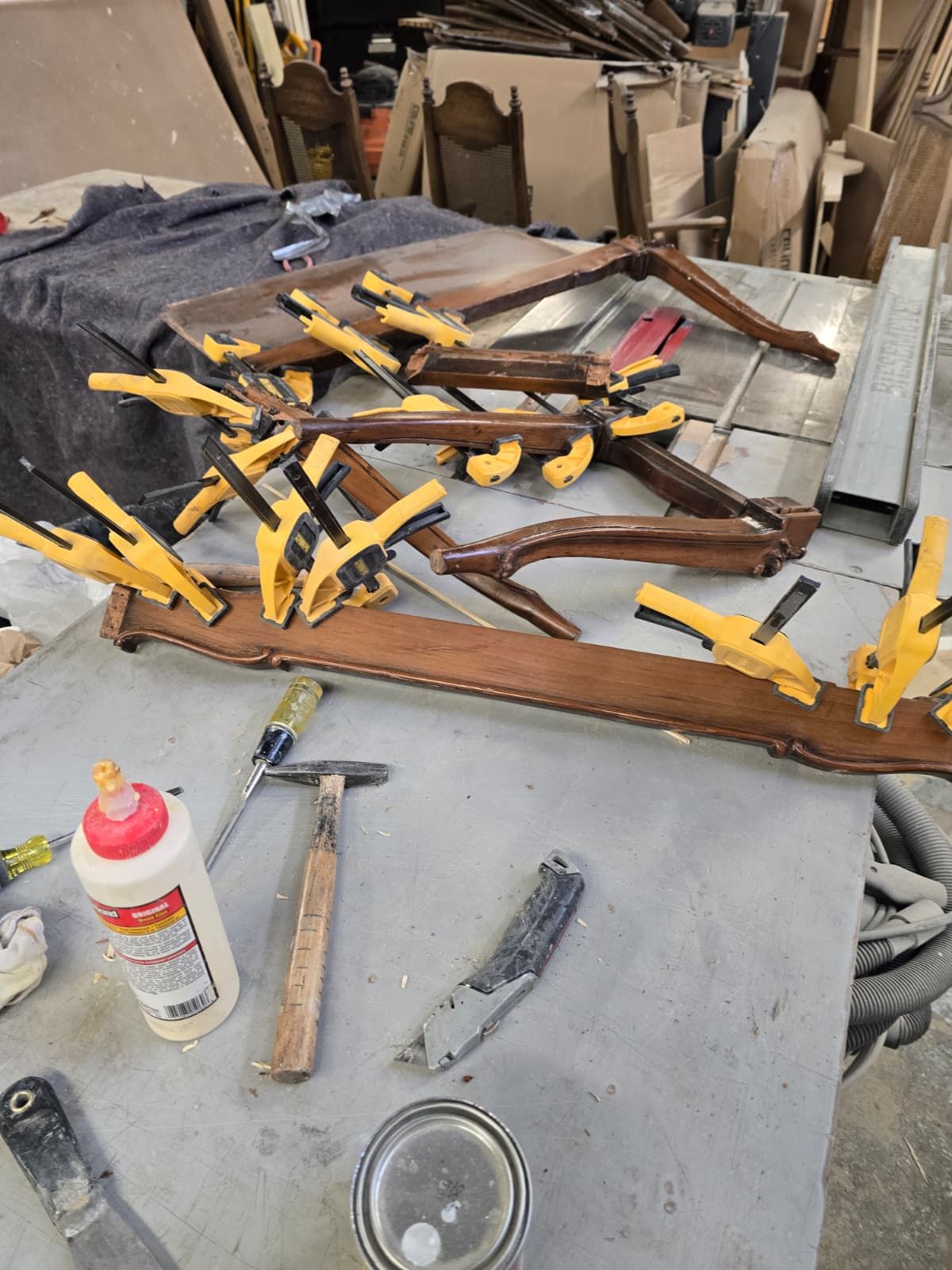 Table frame glued and clamped with many clamps during repair