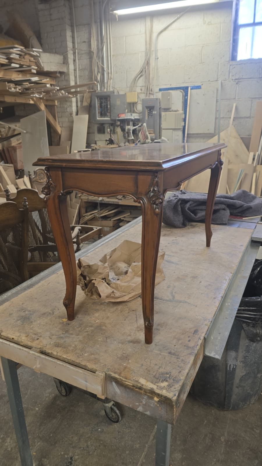 The carved antique table fully restored